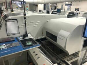 Side facing photo of a Universal GSM GX-11S pick and place machine.